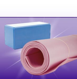 Pink rolled yoga mat beside blue storage box on purple gradient background