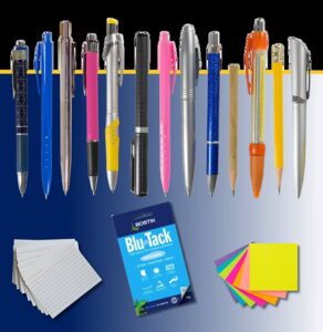 Collection of pens, notepads, Blu Tack adhesive, and sticky notes arranged on blue and white background