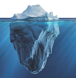 Iceberg partially submerged in ocean water, showing visible tip above surface and large underwater mass below