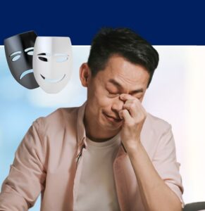 Man with eyes closed, hand to face, with sad and happy theatrical masks floating above, representing emotional regulation and mental health awareness
