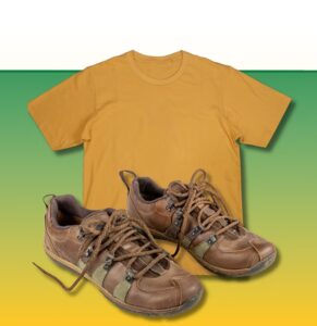 Golden yellow t-shirt displayed above brown lace-up hiking boots on a gradient green-to-yellow background