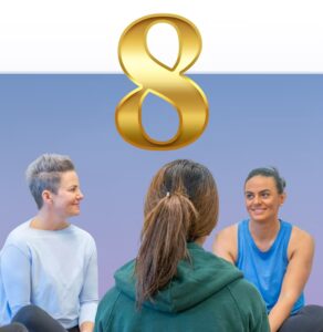 Three people sitting together in conversation with a large gold number 8 above them against a blue gradient background
