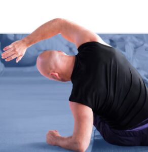 Man performing a stretching exercise on an exercise mat
