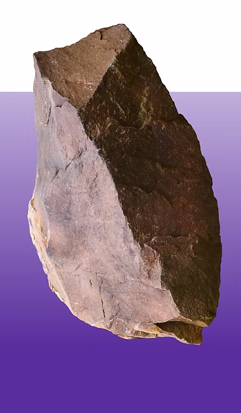 Natural stone specimen showing layered geological formation against purple background