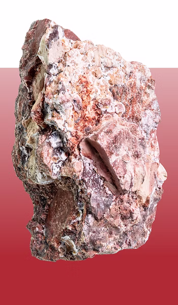 Textured mineral or stone specimen with pink and white crystalline surfaces against gradient background